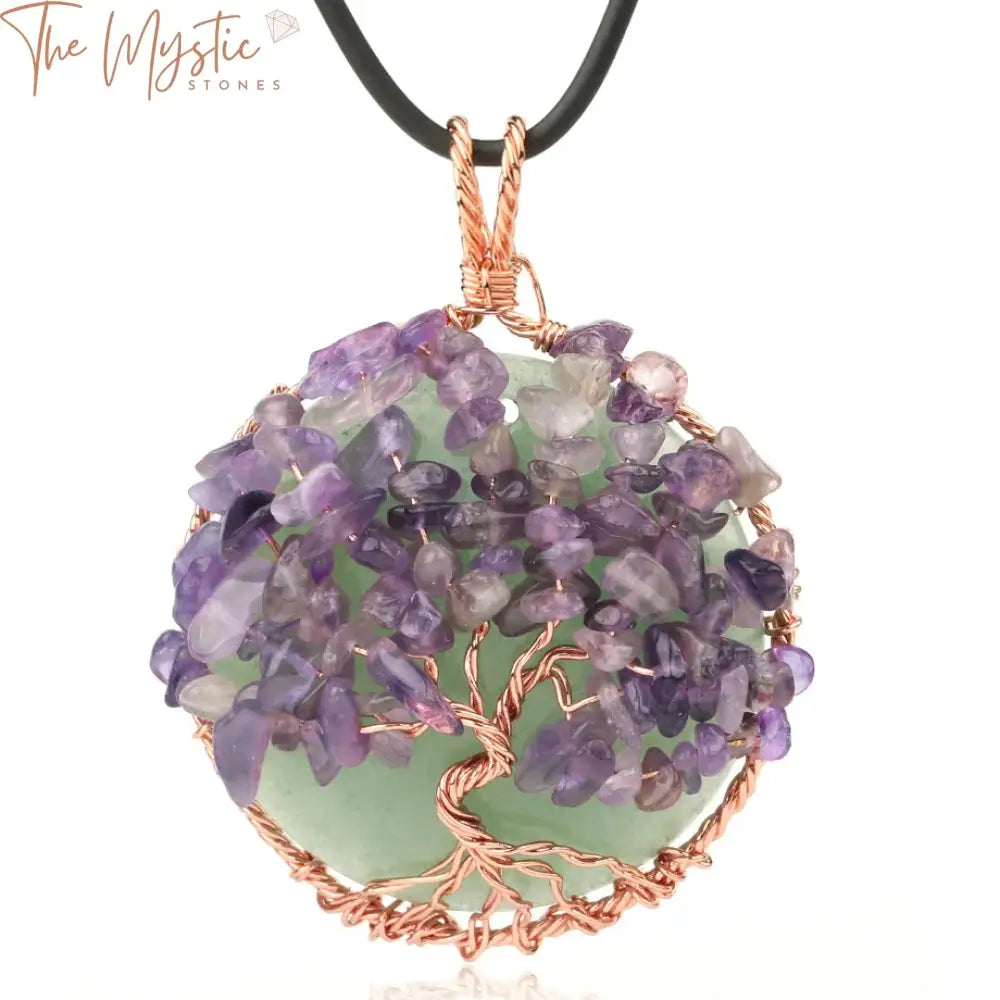 A rose gold wire-wrapped tree of life pendant featuring a trunk and branches intricately crafted with cabochon stones.