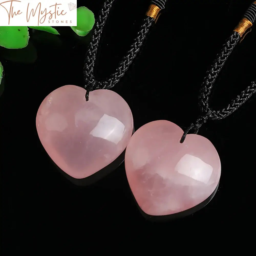 A natural rose quartz crystal pendant shaped like a heart, showcasing a unique pink hue.