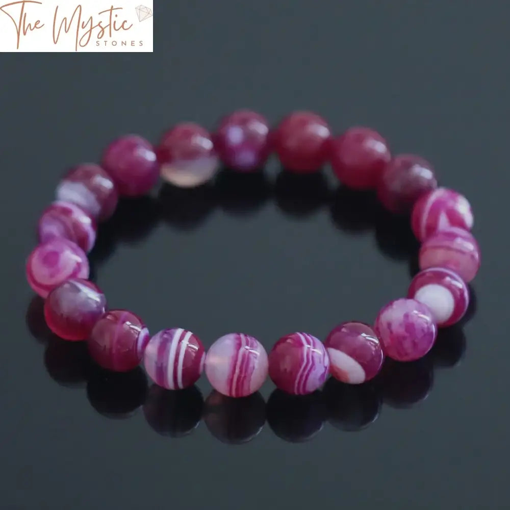 A close-up image of a 10mm rose red onyx bracelet showcasing its natural stretch design.