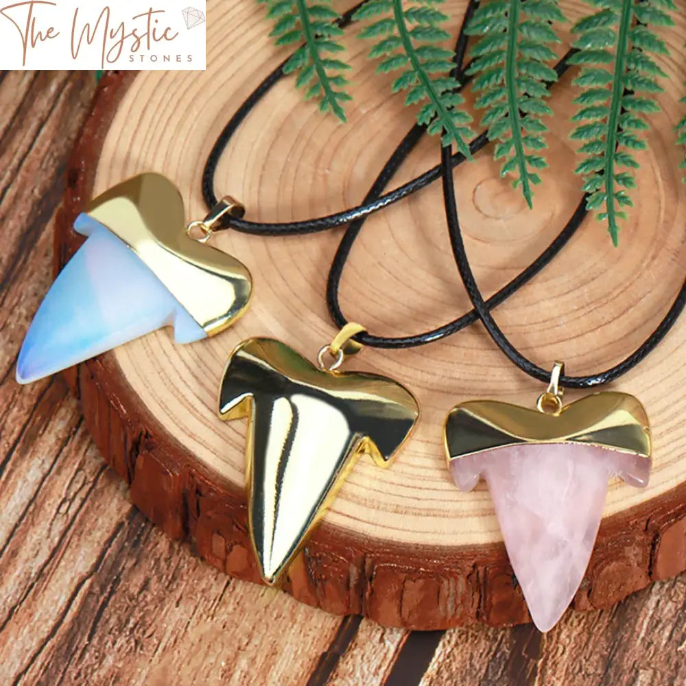 A natural stone pendant necklace featuring a shark tooth-shaped pendant made from healing pink quartz crystal.