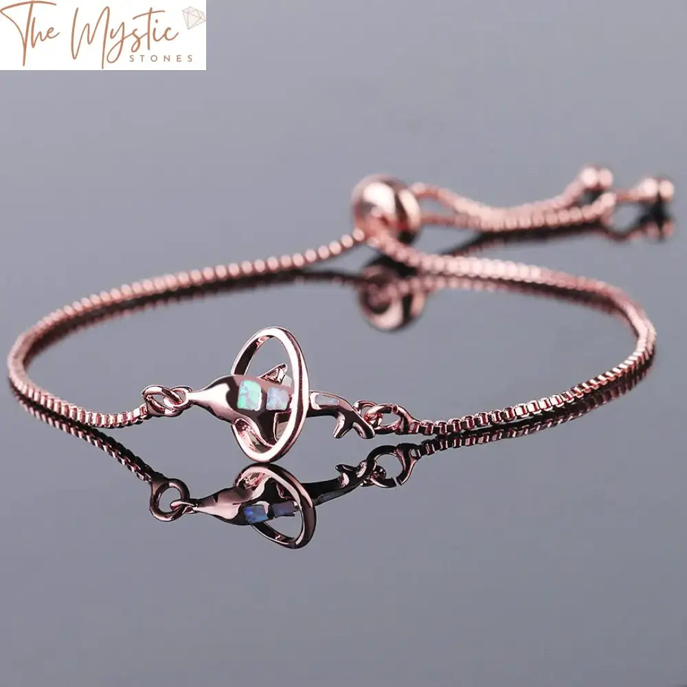 A delicate bracelet featuring a dolphin charm, crafted in a combination of simple style silver and rose gold colors.