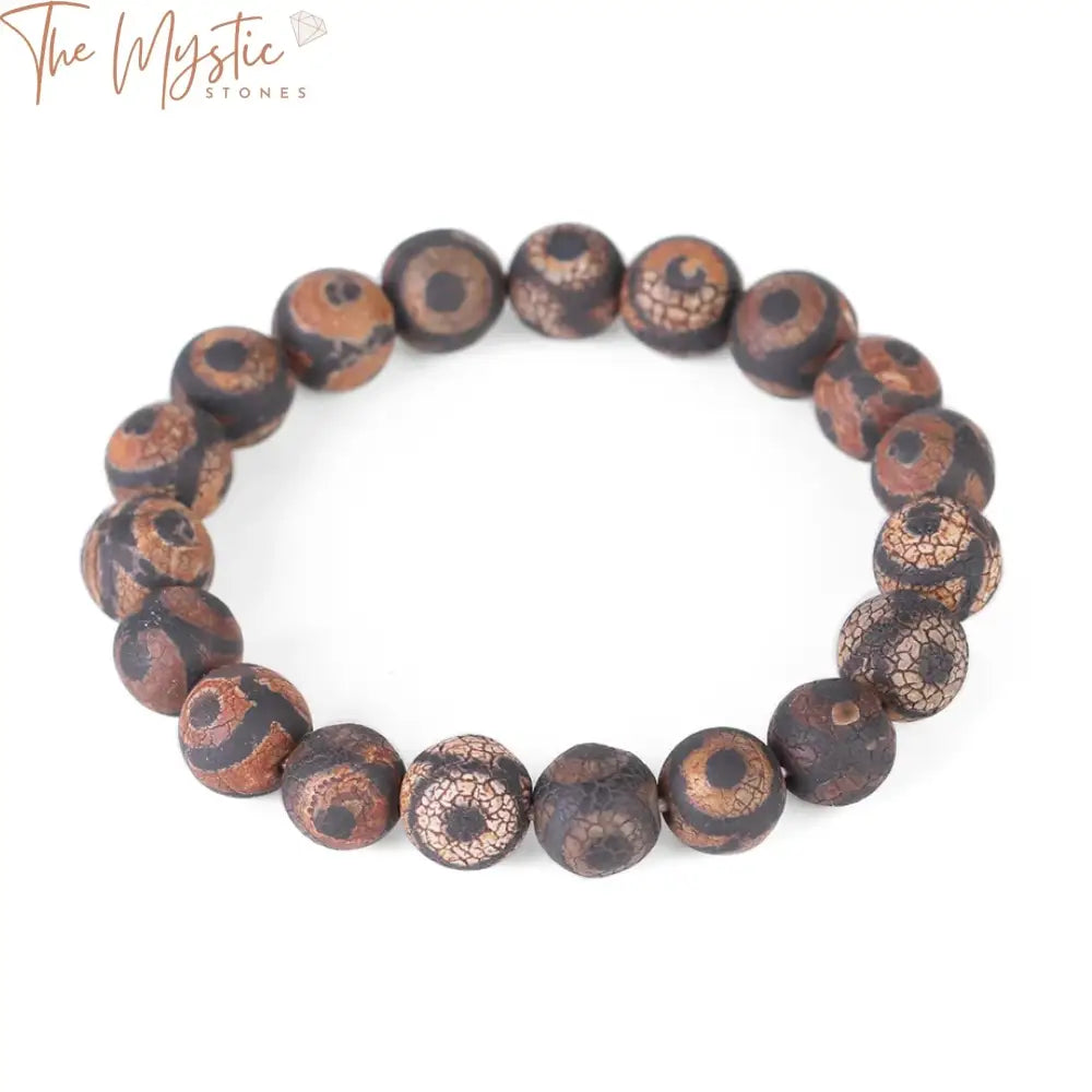 A beaded bracelet featuring round black and brown onyx stones in a striped pattern.