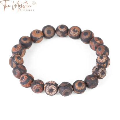 A beaded bracelet featuring round black and brown onyx stones in a striped pattern.