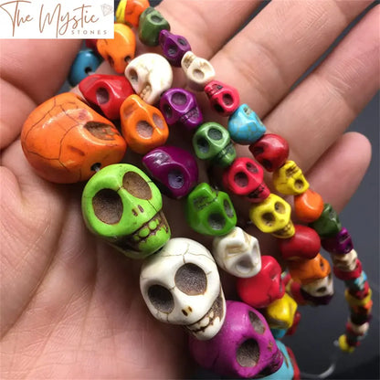 A collection of vibrant synthetic turquoise beads shaped like skulls, arranged loosely on a flat surface.