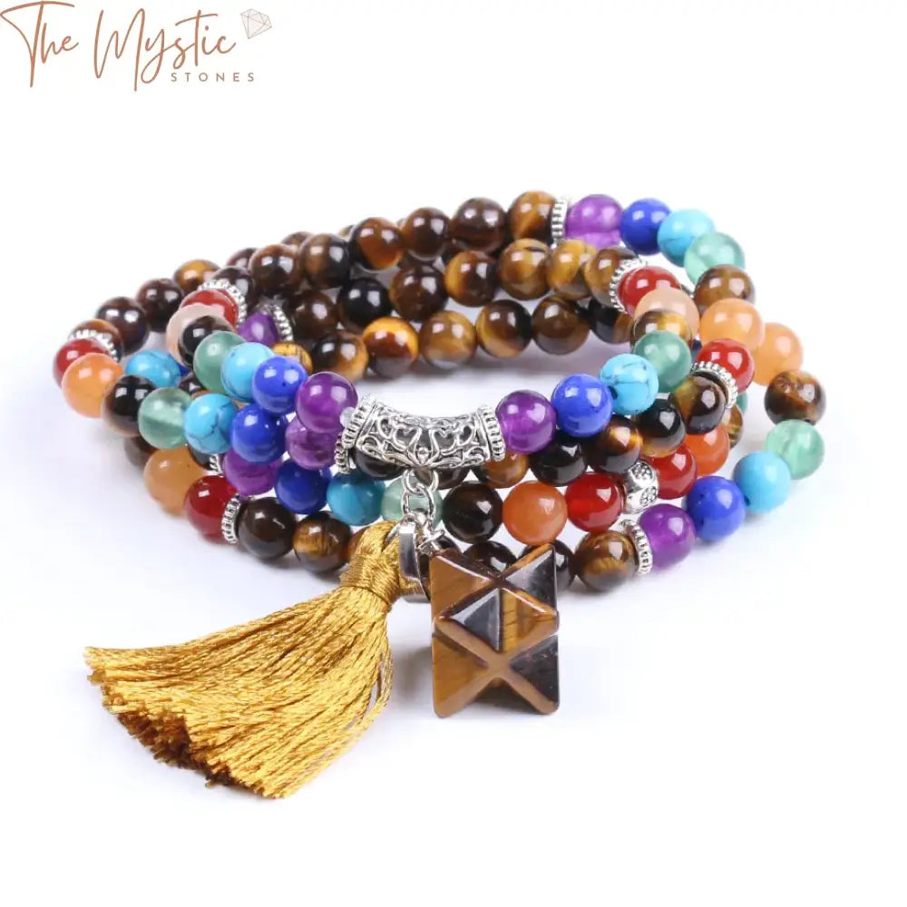 A collection of multi-layered bracelets featuring natural Tiger Eye mala beads, each representing one of the seven chakras.