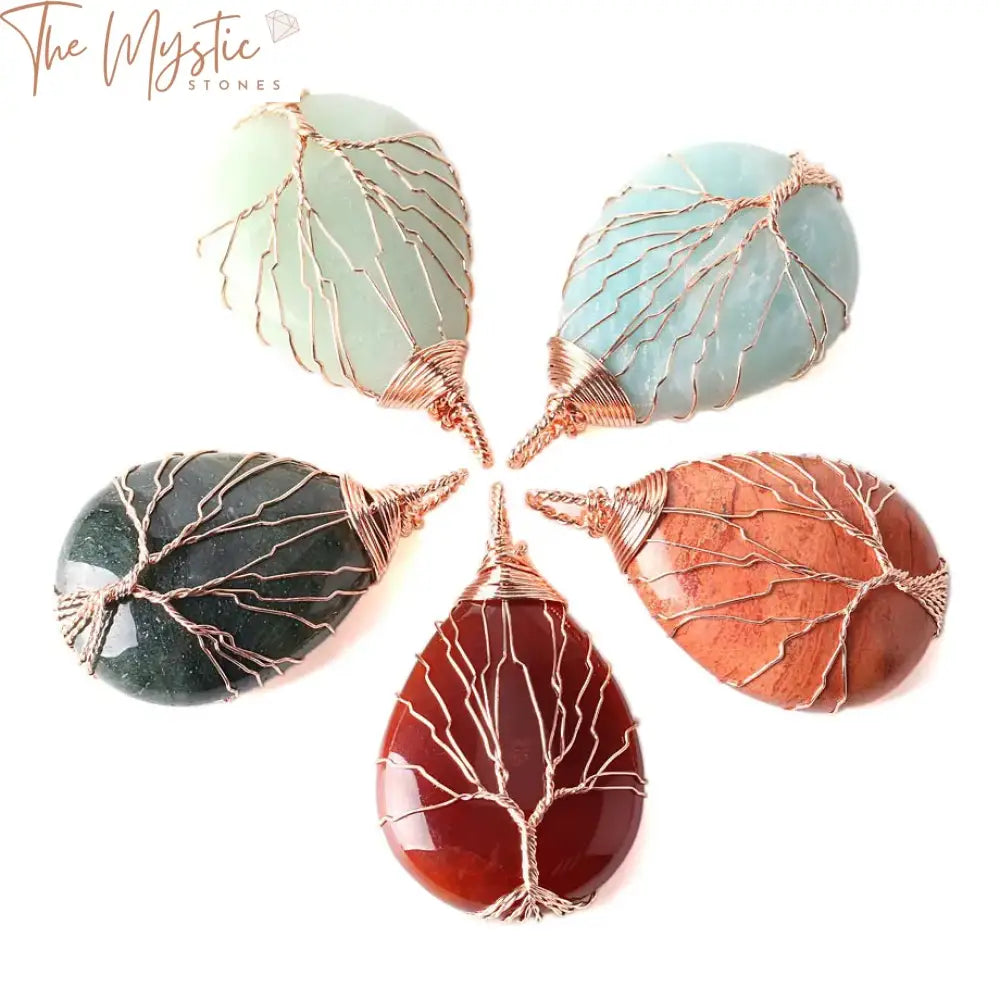 A collection of wire-wrapped tree of life necklaces and pendants displayed against a plain background.