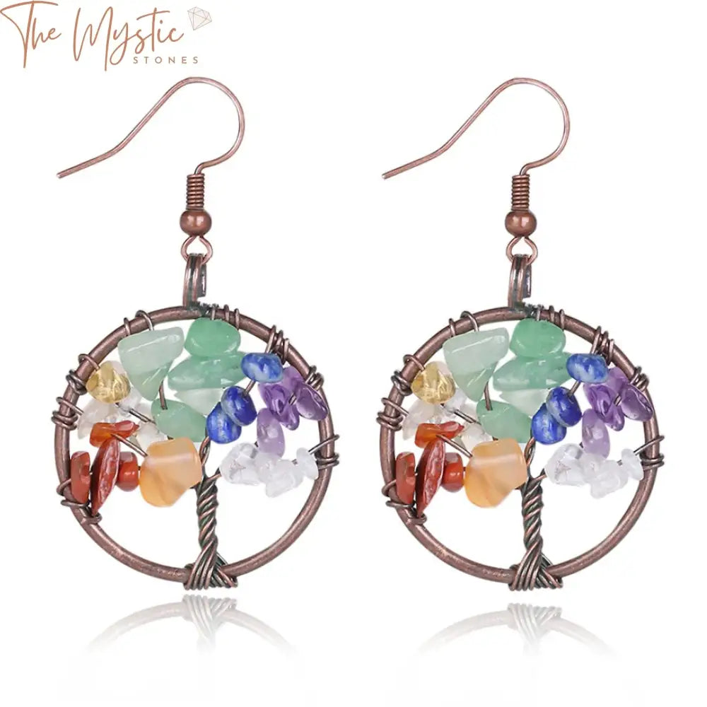 A pair of dangle earrings featuring round Tree of Life pendants.