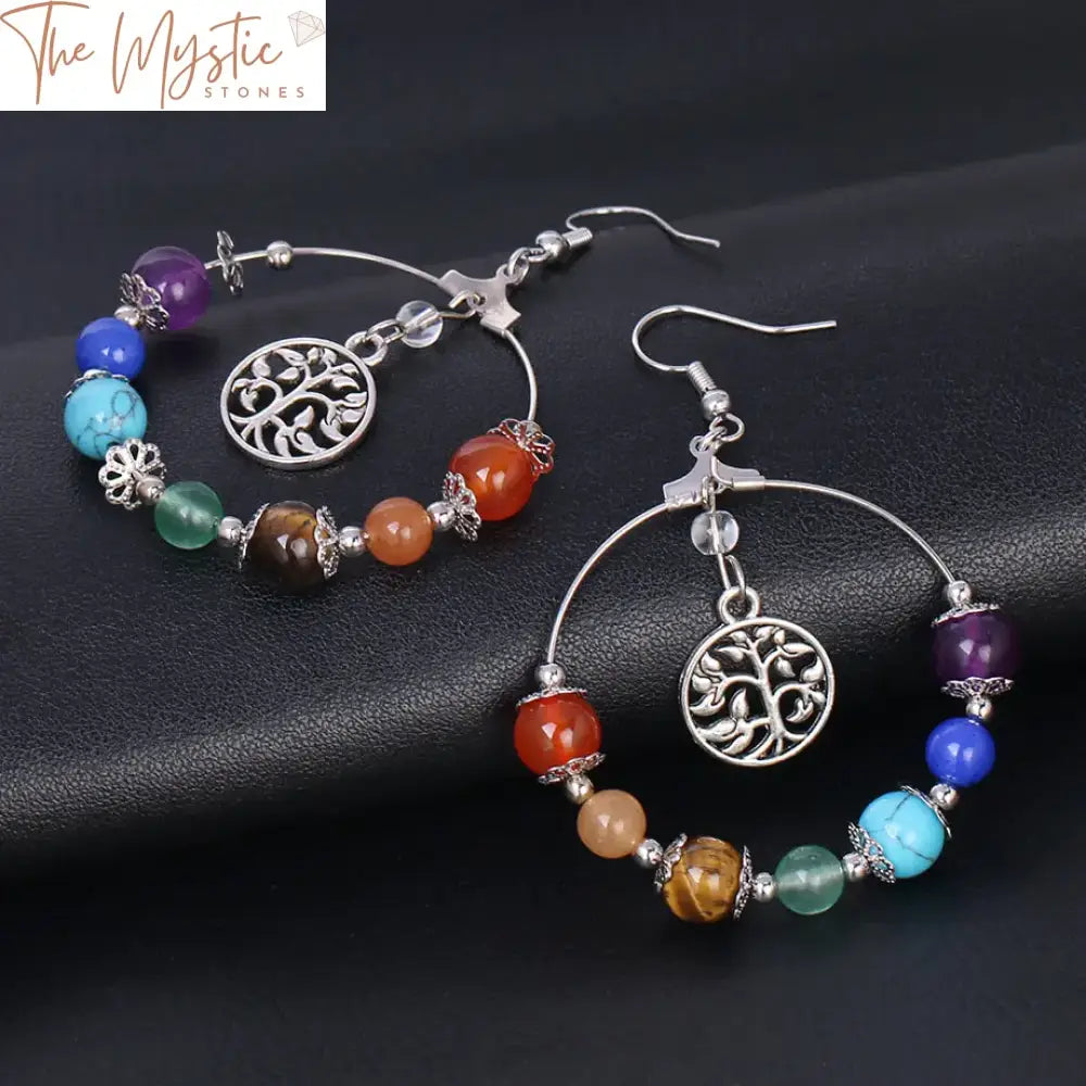 A pair of bohemian-style drop earrings featuring the Tree of Life design.