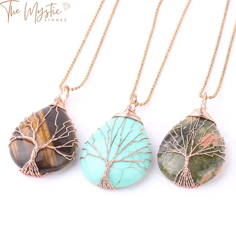 A necklace featuring a Tree of Life pendant in a water drop shape, wrapped with rose gold color wire.