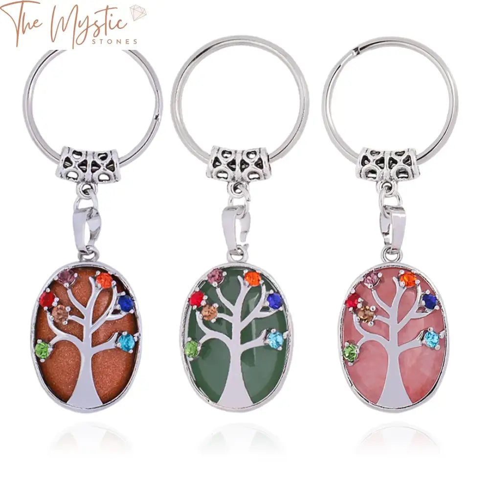 A vibrant keychain featuring an oval crystal pendant with a Tree of Life design made from natural stones.