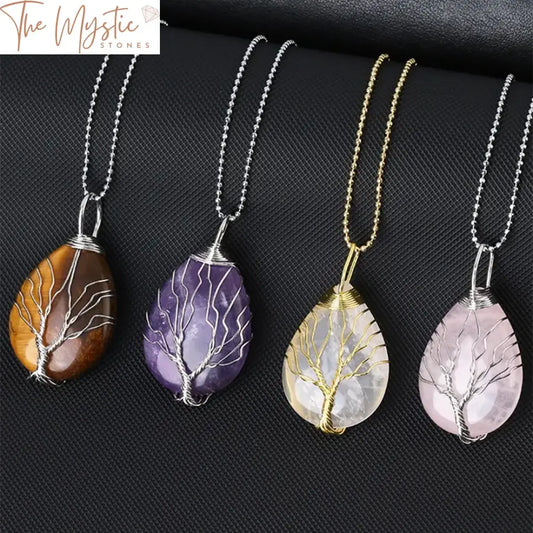 A collection of elegant Tree of Life necklaces featuring water drop-shaped pendants made from natural stones.