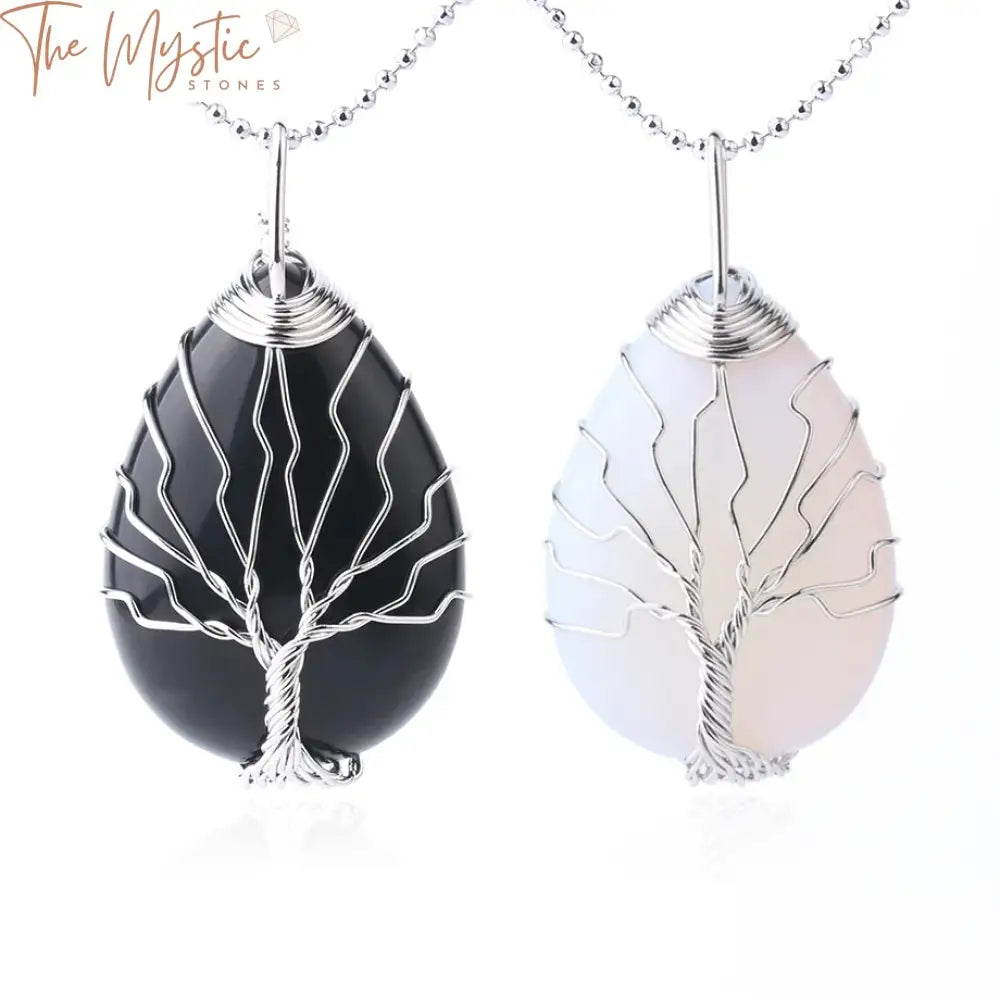 A collection of Tree of Life pendants featuring water drop shapes, intricately wrapped in silver-colored wire.