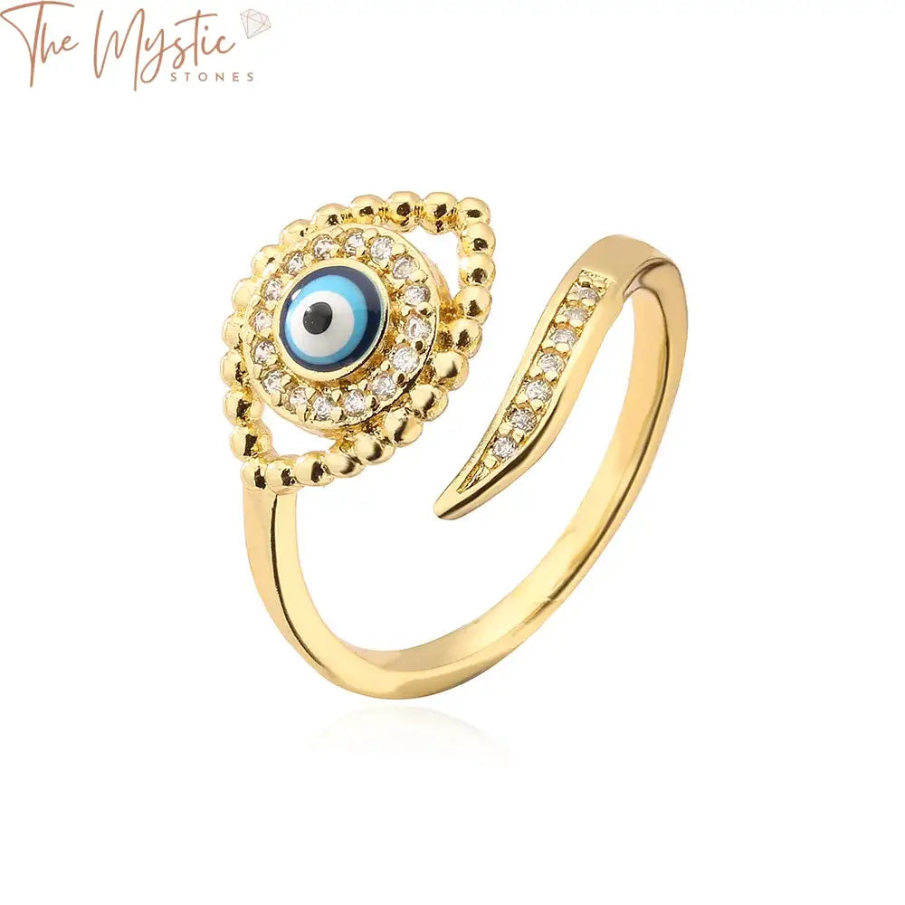 A gold adjustable ring featuring a prominent Turkish blue evil eye design adorned with shimmering cubic zirconia stones.