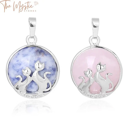 Two intertwined cat silhouettes are artfully engraved on a round pendant, crafted from a polished natural stone.