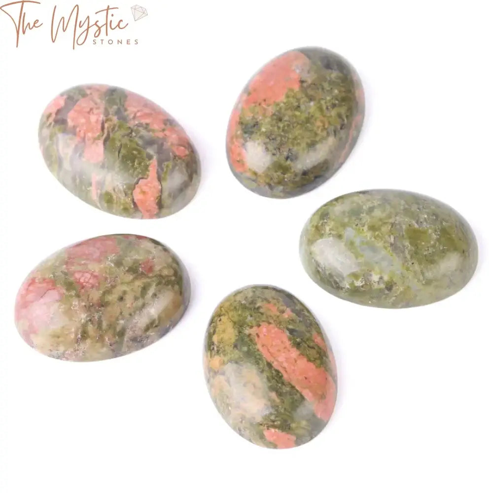 A collection of smooth, dome-shaped natural green Unakite cabochon beads displayed in a scattered arrangement.