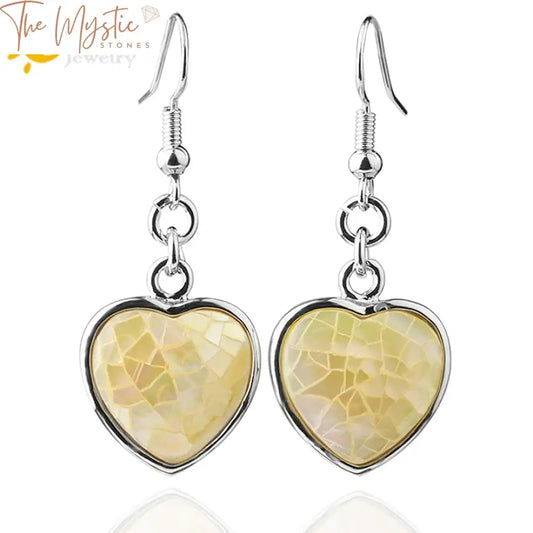 Heart-shaped dangle drop earrings made from white abalone shell, designed in a trendy reiki style.