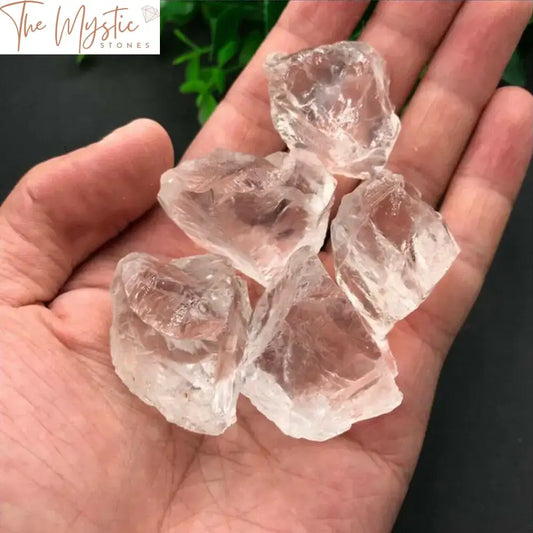 A collection of raw, natural white and clear crystal specimens displayed in a small pile.