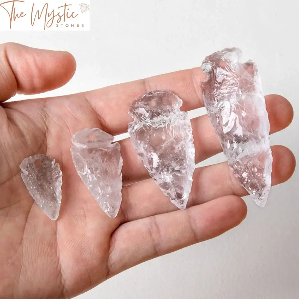 A natural white crystal pendant in the shape of an irregular arrowhead, featuring clear quartz with a polished finish.