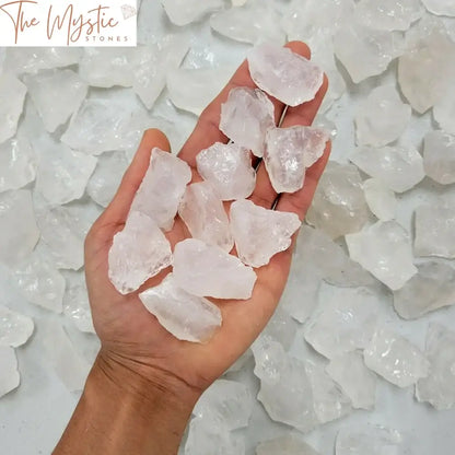 A collection of rough, natural white quartz crystals displayed against a plain background.