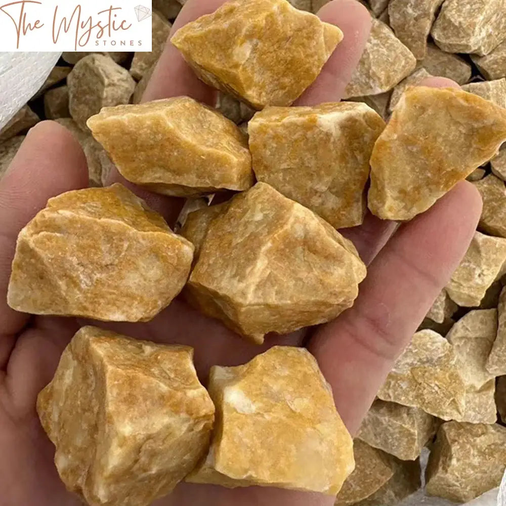 A collection of natural yellow aventurine rough stones with irregular shapes displayed on a flat surface.