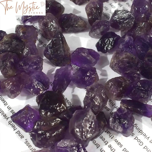 A natural, unpolished dark purple Amethyst Quartz gemstone from Zambia, showcasing its raw and jagged texture.